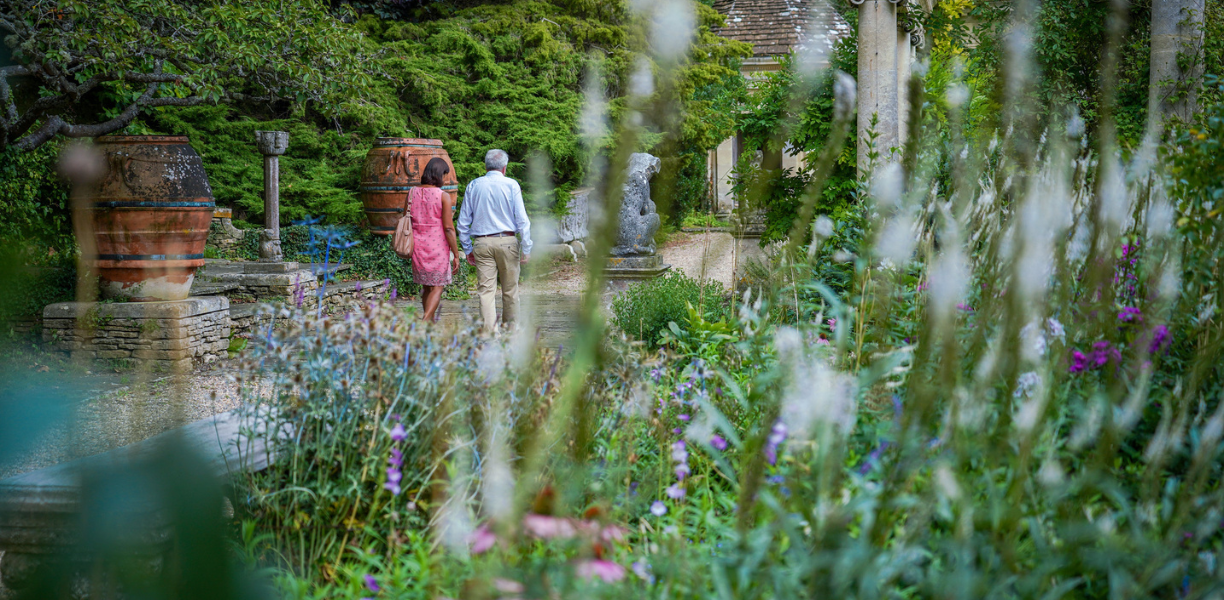 Couple walking through Iford Manor Gardens